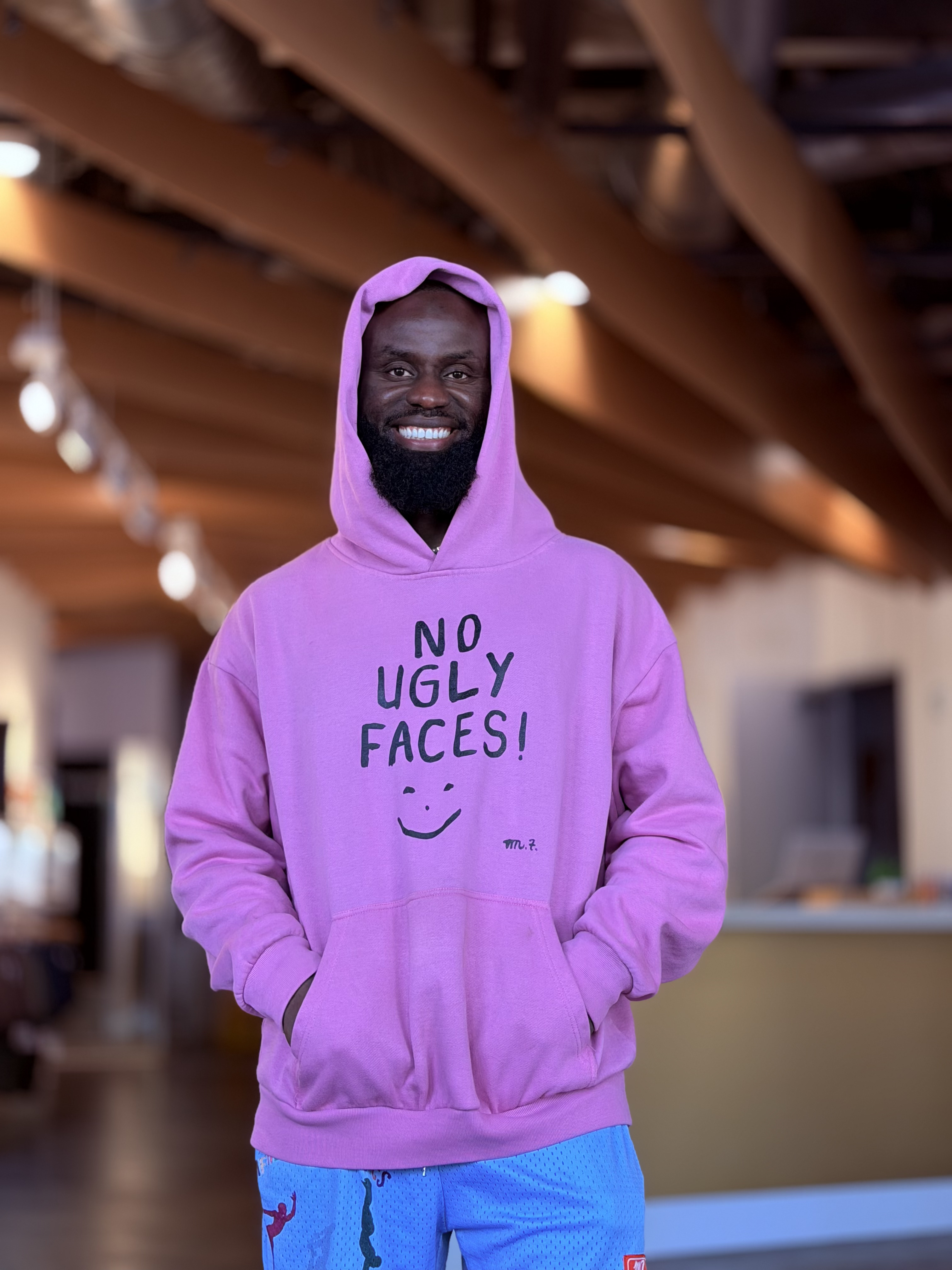 Mo wearing the pink No Ugly Faces hoodie