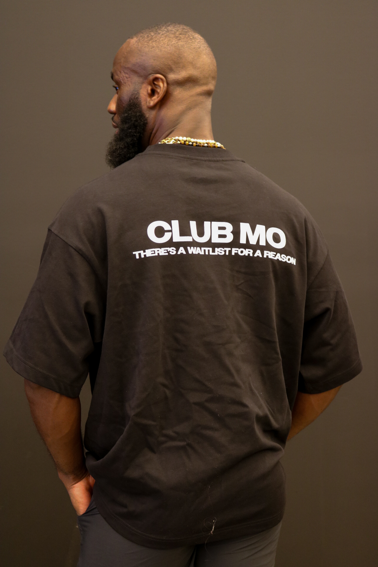 Mo wearing a black CLUB MO tee
